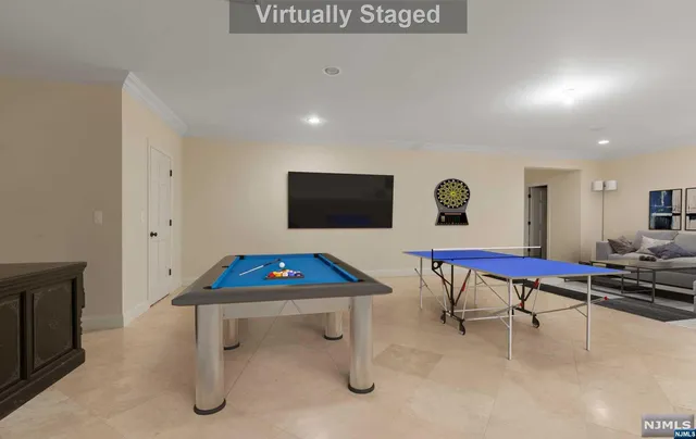 a living room with furniture pool table and a flat screen tv