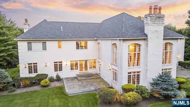 51 Chestnut Ridge Road Saddle River, NJ 07458 - Photo 38 of 45 a front view of a house with a yard and outdoor seating