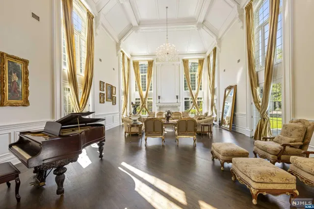 a living room with fireplace furniture and a large window