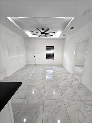 a view of a livingroom with a ceiling fan and window