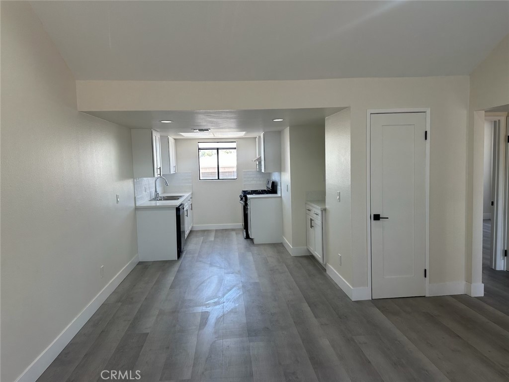 44155 10th Lancaster, CA 93534 - Photo 5 of 15 a view of a kitchen with wooden floor electronic appliances and windows