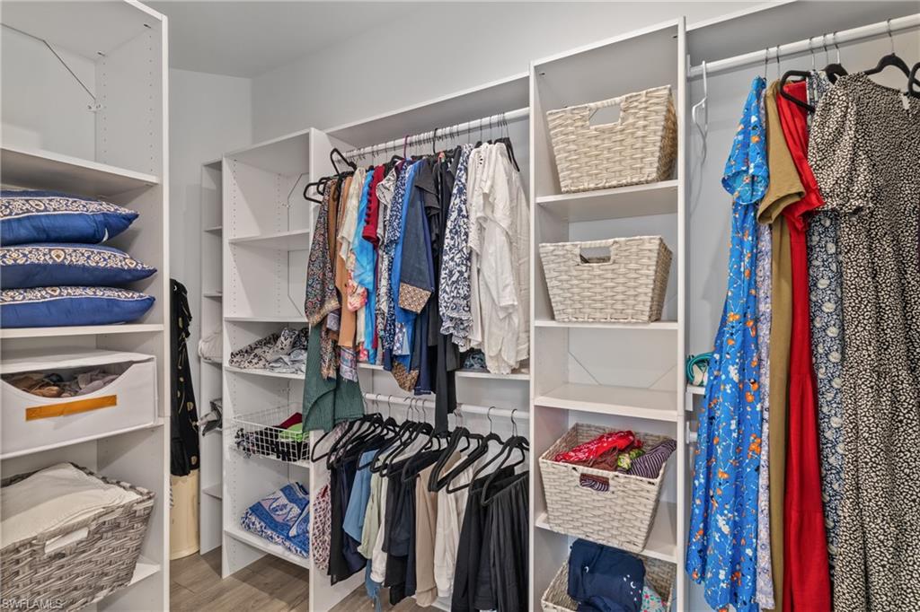 9637 Montelanico Loop, Unit 104 Naples, FL 34119 - Photo 14 of 45 Walk in closet featuring light wood-type flooring