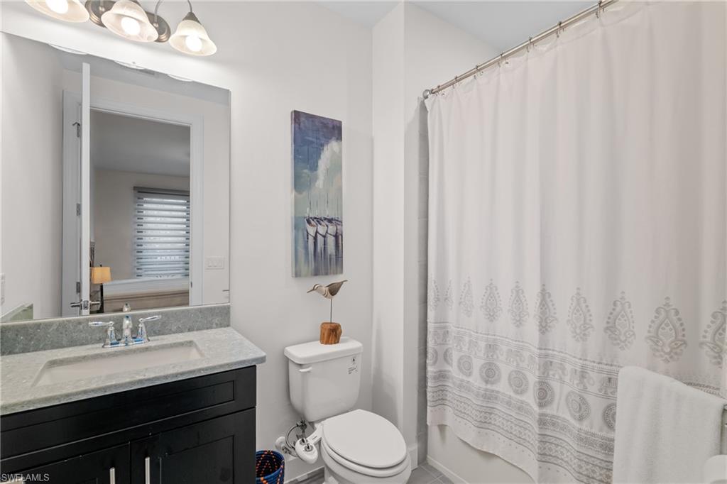 9637 Montelanico Loop, Unit 104 Naples, FL 34119 - Photo 18 of 45 Full bath featuring vanity and shower / tub combo with curtain