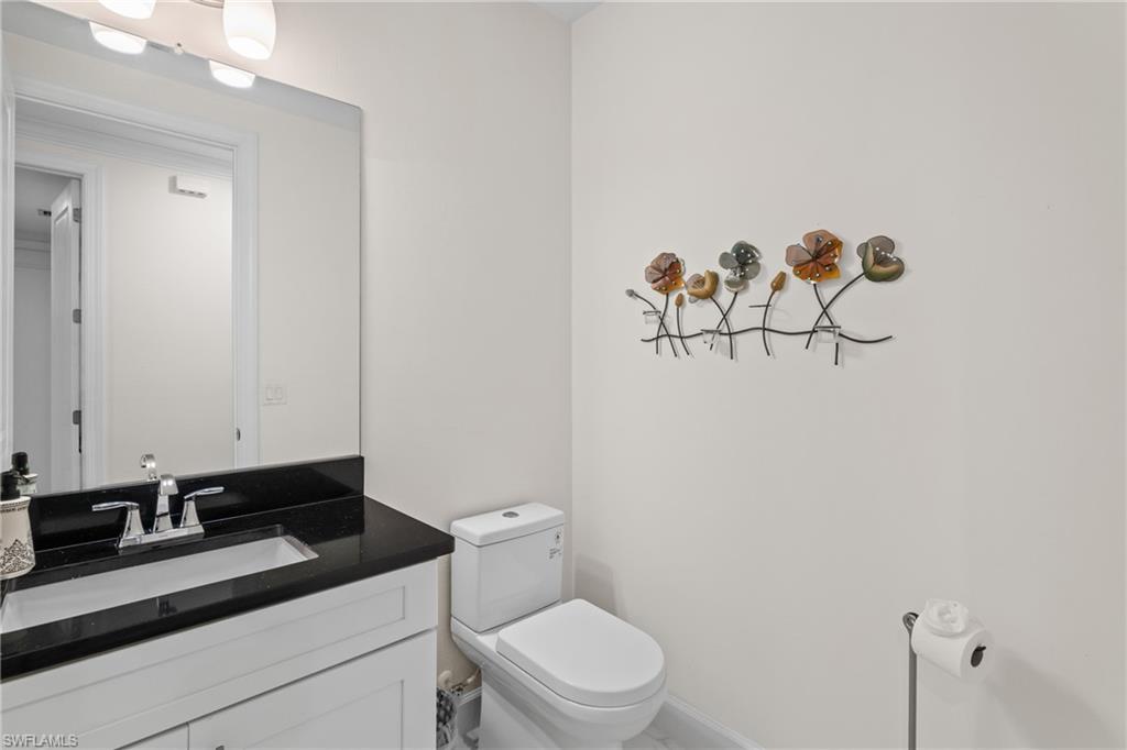 9637 Montelanico Loop, Unit 104 Naples, FL 34119 - Photo 19 of 45 Bathroom featuring vanity and toilet
