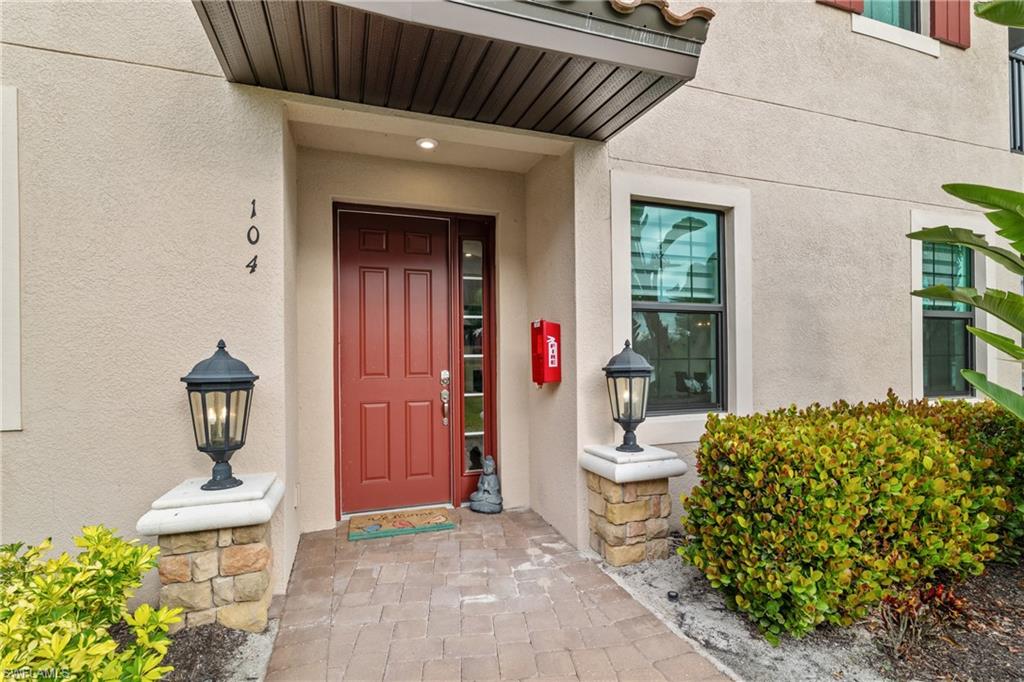 9637 Montelanico Loop, Unit 104 Naples, FL 34119 - Photo 25 of 45 Entrance to property with stucco siding