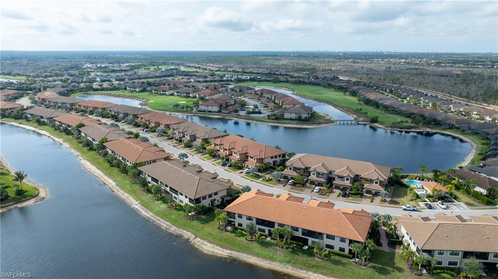9637 Montelanico Loop, Unit 104 Naples, FL 34119 - Photo 28 of 45 Aerial view of residential area with a large body of water