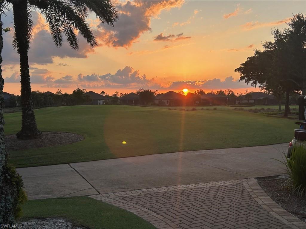 9637 Montelanico Loop, Unit 104 Naples, FL 34119 - Photo 40 of 45 View of community featuring a lawn and view of golf course