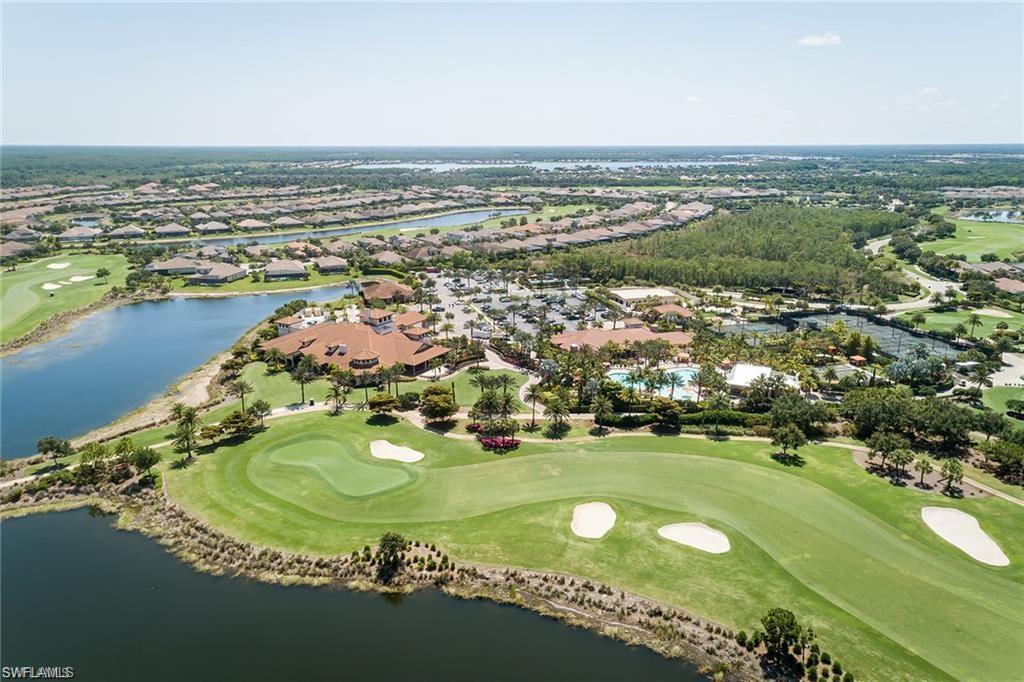 9637 Montelanico Loop, Unit 104 Naples, FL 34119 - Photo 41 of 45 Aerial view of property's location with a golf course, a large body of water, and nearby suburban area