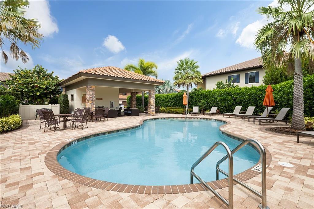 9637 Montelanico Loop, Unit 104 Naples, FL 34119 - Photo 42 of 45 Community pool with a patio area and outdoor lounge area