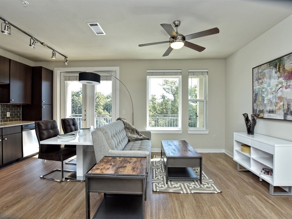 a living room with furniture a fireplace and a table