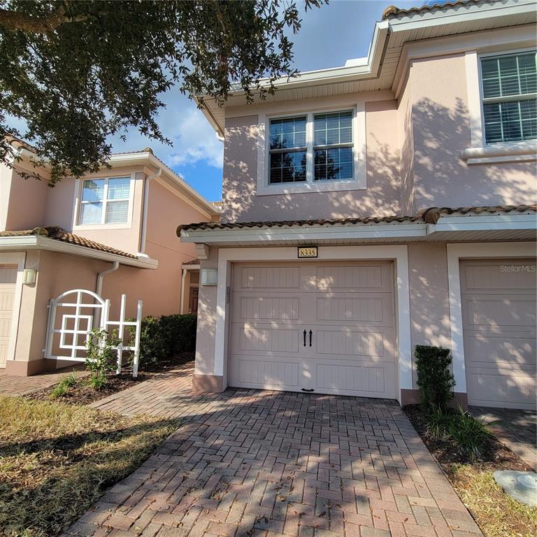 8335 Bella Vida Circle, Unit 8335 Davenport, FL 33896 - Photo 1 of 16 a front view of a house with a yard
