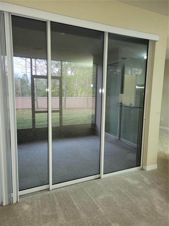 8335 Bella Vida Circle, Unit 8335 Davenport, FL 33896 - Photo 14 of 16 an empty room and sliding glass door