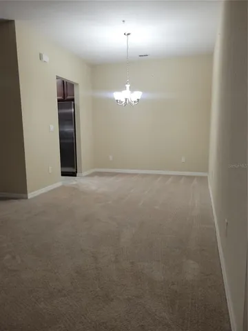 a view of a chandelier fan and fire place