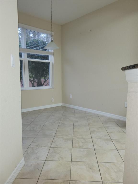 8335 Bella Vida Circle, Unit 8335 Davenport, FL 33896 - Photo 5 of 16 a view of an empty room with a fireplace and a fan