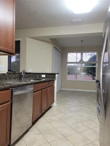 a kitchen with stainless steel appliances granite countertop a sink and a stove