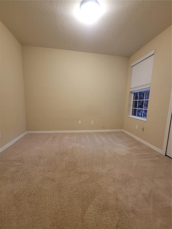 8335 Bella Vida Circle, Unit 8335 Davenport, FL 33896 - Photo 8 of 16 an empty room with windows
