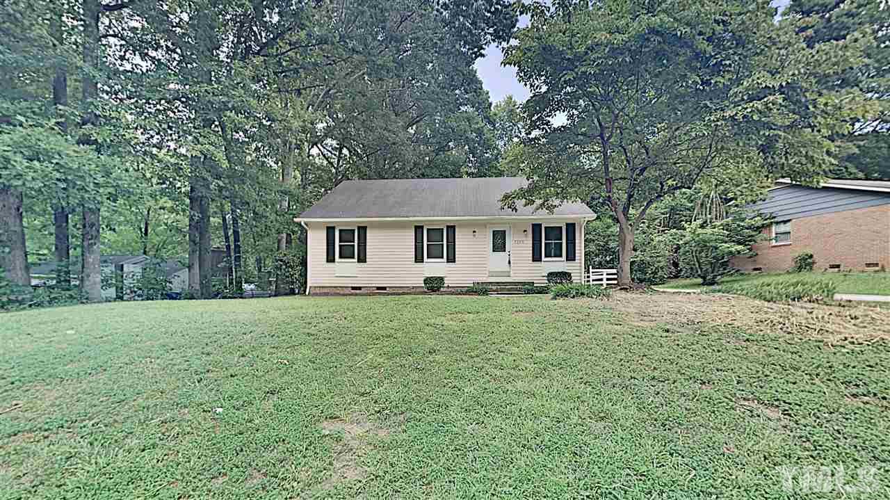 7209 Stuart Drive Raleigh, NC 27615 - Photo 1 of 13 a front view of a house with a garden