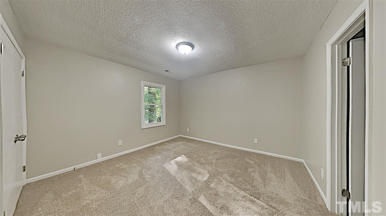 7209 Stuart Drive Raleigh, NC 27615 - Photo 6 of 13 a view of an empty room and a window