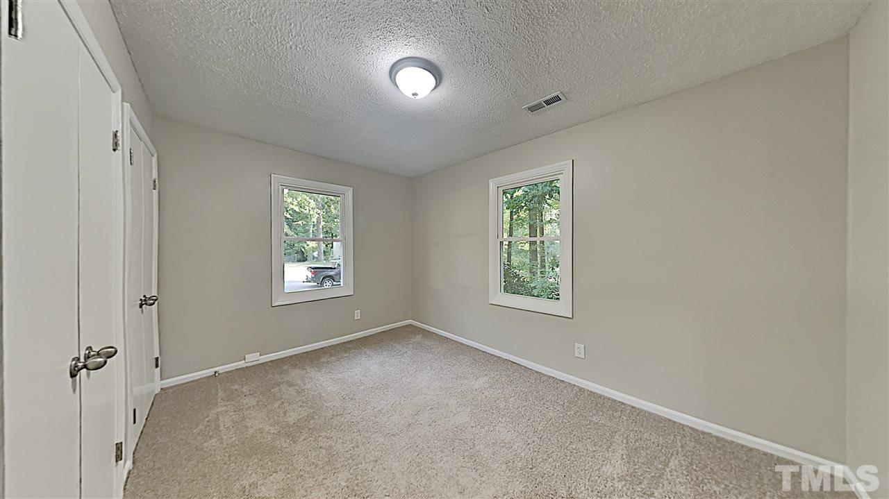 7209 Stuart Drive Raleigh, NC 27615 - Photo 8 of 13 a view of an empty room with a window