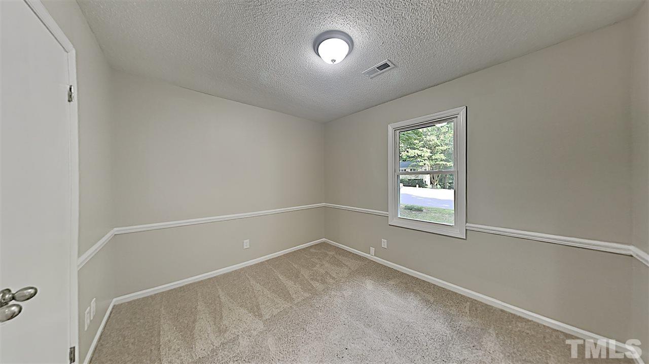 7209 Stuart Drive Raleigh, NC 27615 - Photo 9 of 13 an empty room with windows