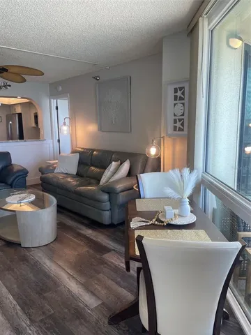 a living room with furniture and a lamp