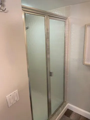 a bathroom with a granite countertop sink a mirror and a bathtub