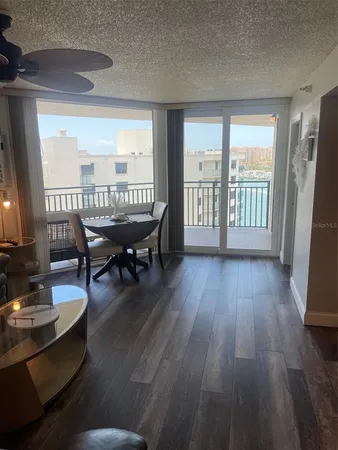 a dining room with furniture window and wooden floor