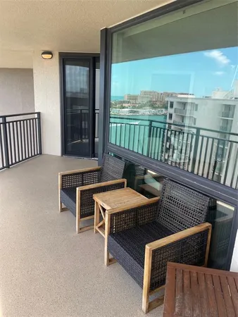 a reading room with furniture and a large window