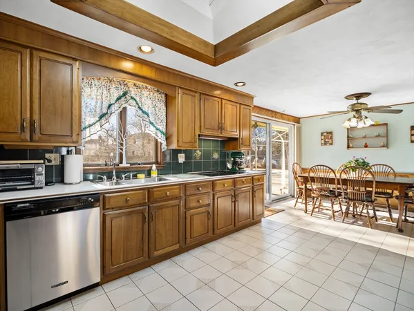 a kitchen with cabinets and chairs