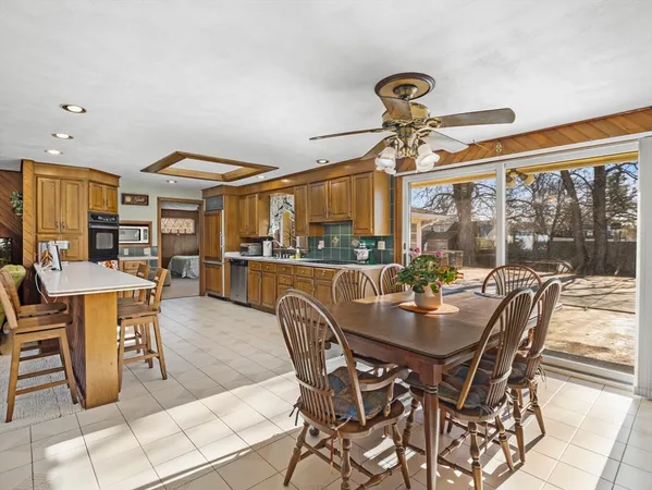 a dining room with furniture a chandelier and a rug