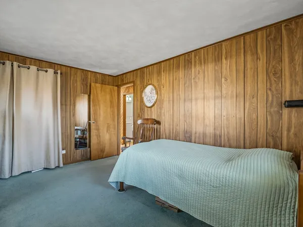 a bedroom with a bed and cabinets