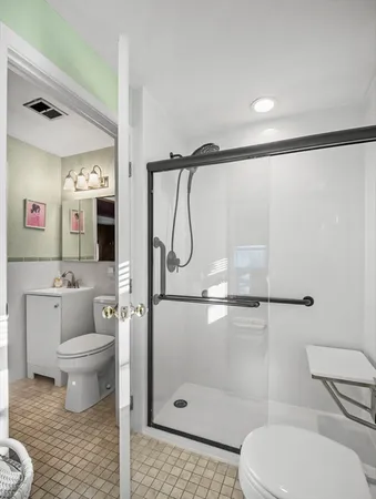a bathroom with a toilet sink and shower