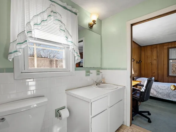 a bathroom with a sink a toilet and a mirror