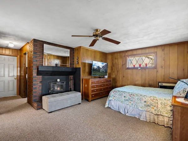 a bedroom with bed and a tv