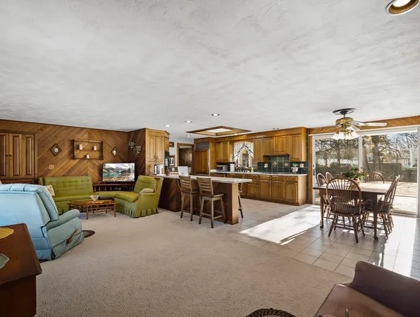 a living room with furniture a flat screen tv and a table
