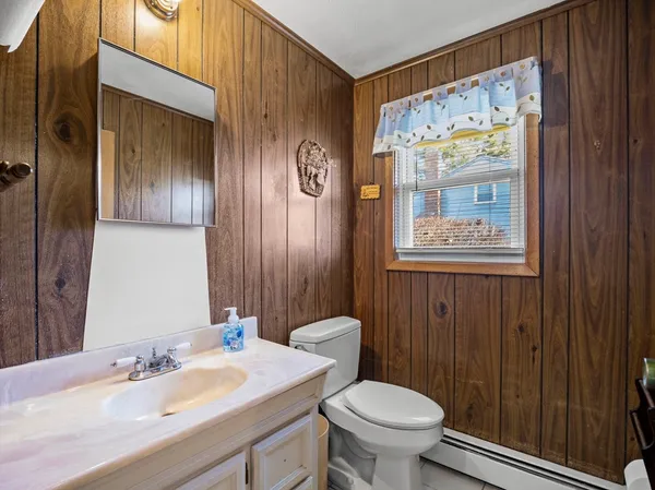 a bathroom with a sink a toilet and shower curtain