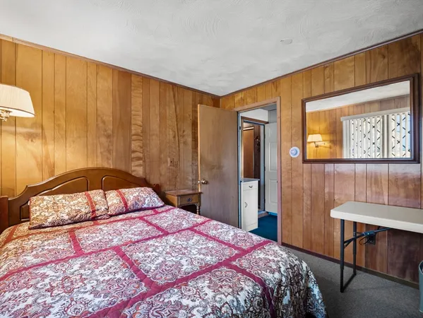 a bedroom with a bed and a dresser