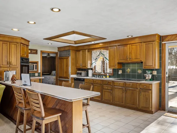 a kitchen with stainless steel appliances granite countertop a sink and cabinets
