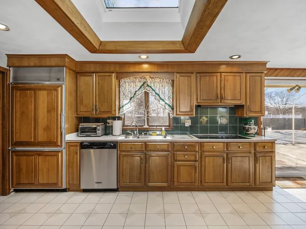 a kitchen with stainless steel appliances granite countertop a stove a sink and a refrigerator