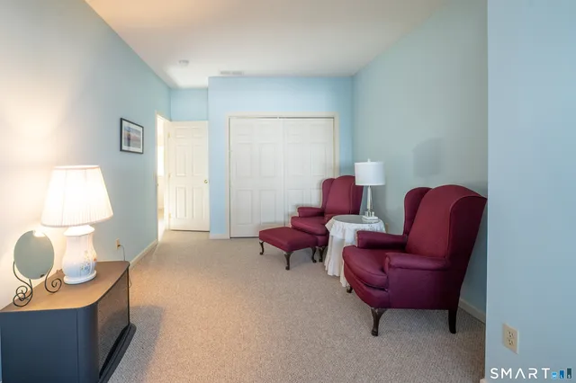 a living room with furniture and a chair