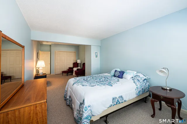 a bedroom with a bed and a table in it