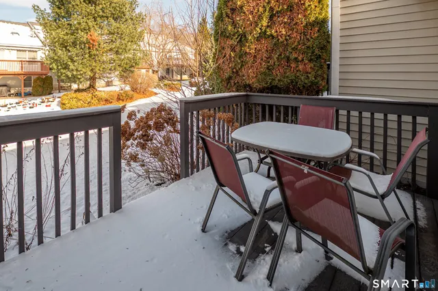 a view of a chairs and table in the balcony