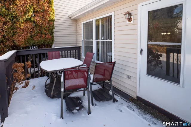 a view of a patio with a table and chairs