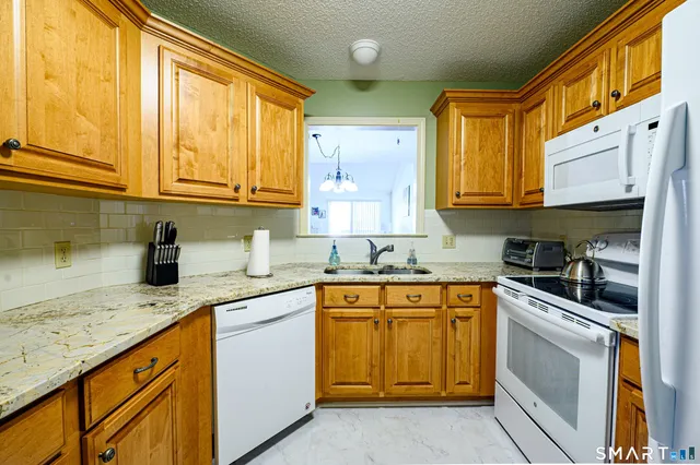 a kitchen with stainless steel appliances granite countertop a sink and cabinets