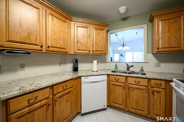 a kitchen with stainless steel appliances granite countertop a sink and cabinets