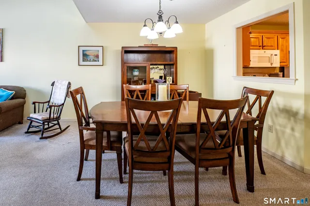 a view of a dining room with furniture and a chandelier