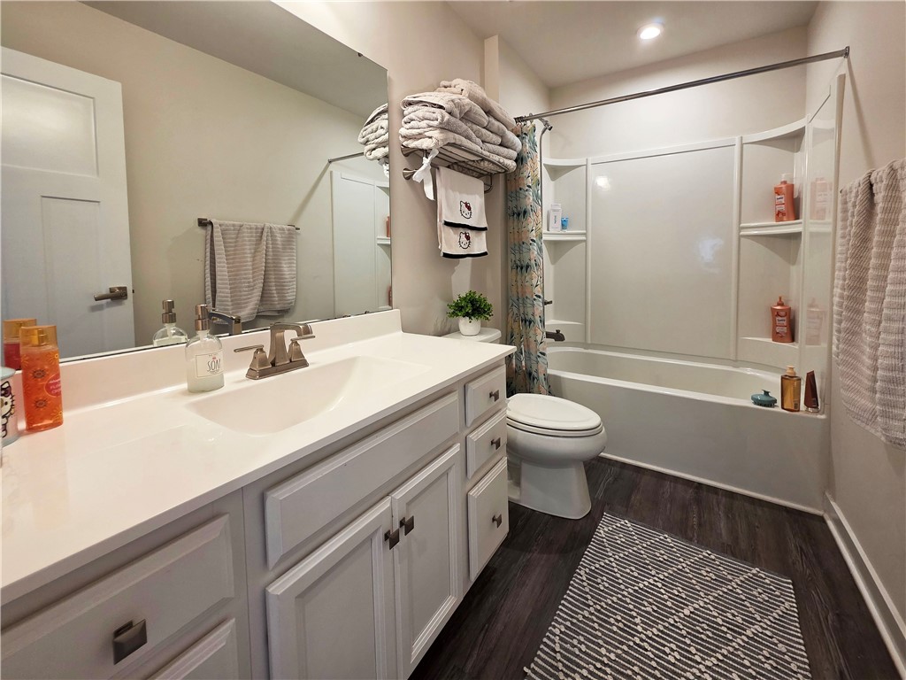 224 Bronson Ridge Anderson, SC 29621 - Photo 12 of 42 A well-lit bathroom with a clean, white vanity and dark wood-look flooring.