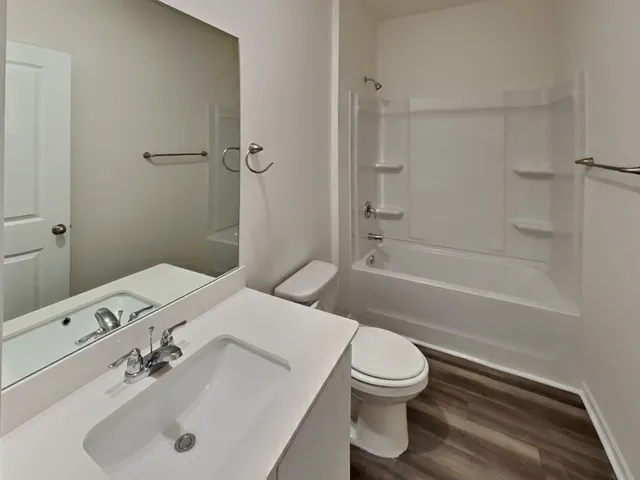 a bathroom with a sink toilet tub and shower