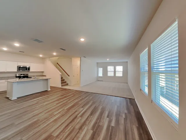 a view of kitchen with sink and wooden floor