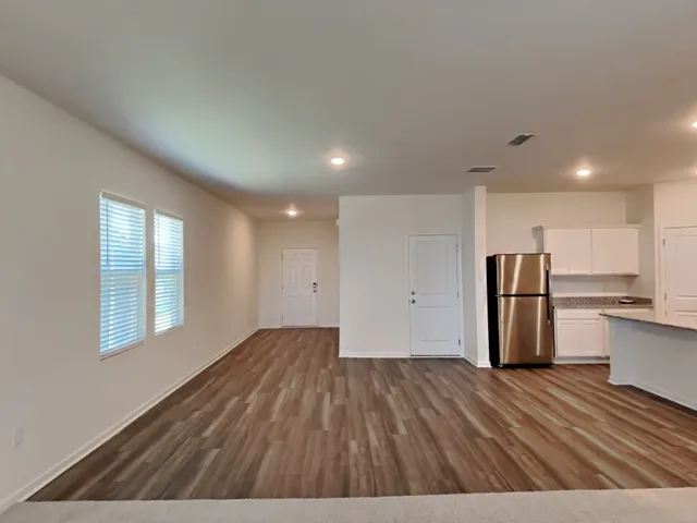 a view of kitchen with wooden floor and electronic appliances